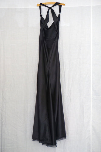 Full length 100% silk satin dress with knot in back and knotted at front end of straps. The bias cut gives this dress great flow.  Silk chiffon trim on bottom hem. Lined in silk.