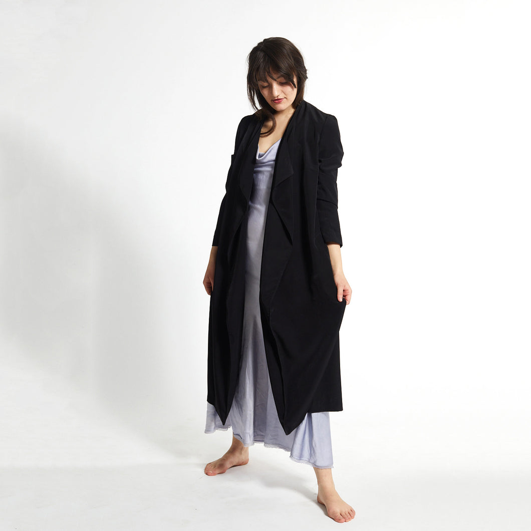 A coat in high-quality microfiber that has a silky appearance and falls beautifully.  Model in photo is wearing size Medium.